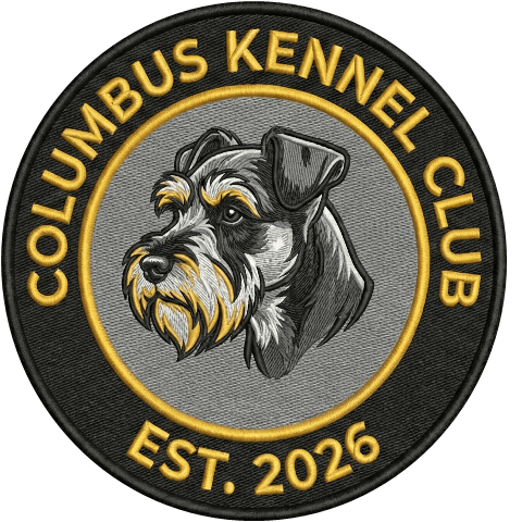 Columbus Kennel Club patch: a miniature schnauzer inside a black and gold ring, Est. 2026